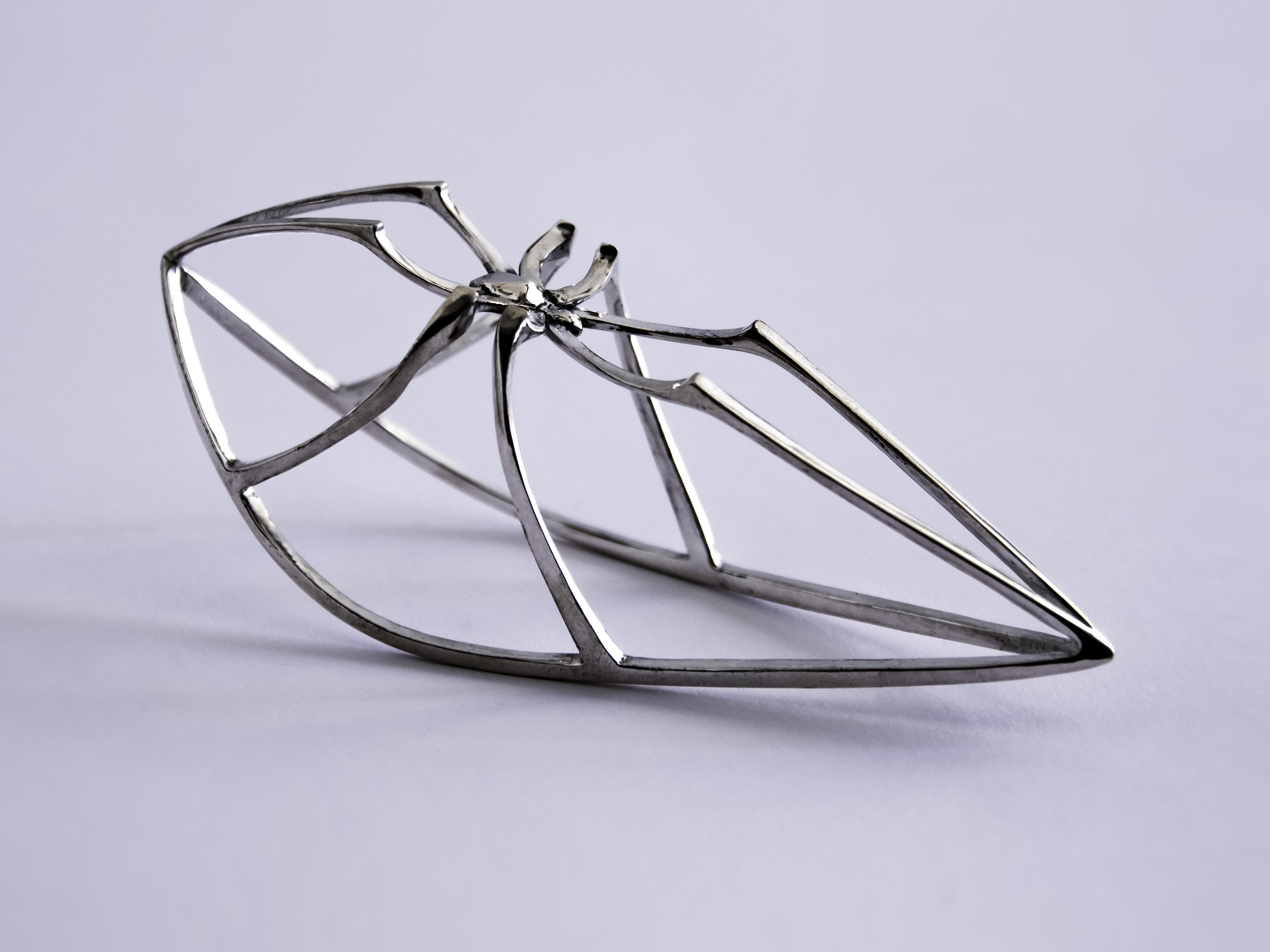 A spindly, silver, spider version of a rocking horse.